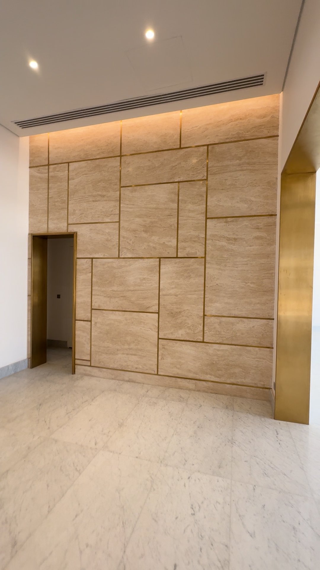 Travertine and brass corridor wall